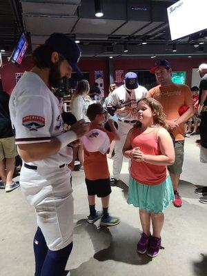 Players signing autographs after the game.