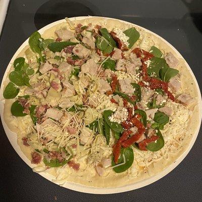 Half chicken Chicken Bacon Artichoke (Baking Required) And half Herb Chicken Mediterranean Pizza (Baking Required) on thin crust.