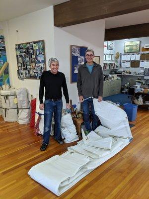 Frank and Axel are holding my 30 year old storm jib which they serviced and replaced all grommets and hanks.