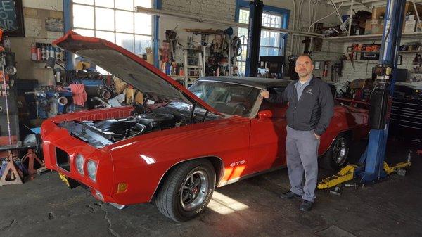 Luis standing next to my GTO at Eagle Auto Repair.  He fixed my car's ongoing issues in just a few hours!