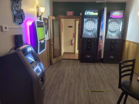 Dart boards, juke box, ATM.  The curtain between the dart boards is a selfie background for the jukebox selfie-cam.