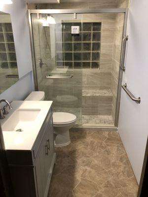 Finished bathroom with built in shower seat .