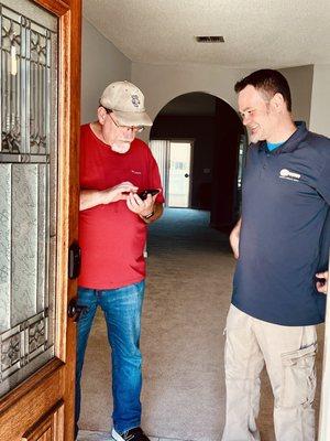 Travis helping us set up Schlage's smart lock online.