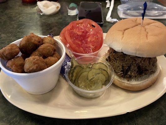 Beef brisket sandwich with a fried okra side.