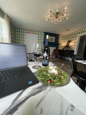 Girl lunch  arugula salad with goat cheese and a bottle of the Walking fool