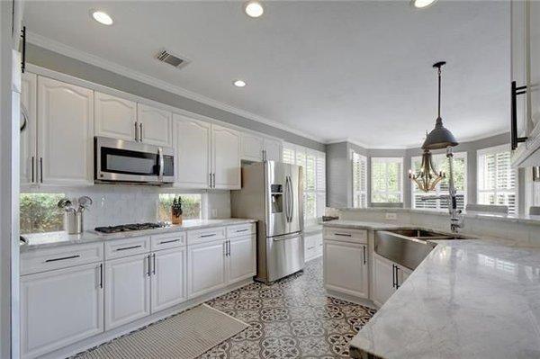 Kitchen renovation - new cementine tile floors, lighting, countertops and a built-in in the breakfast