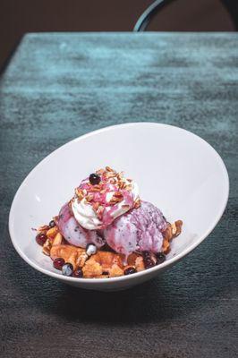 The Huckleberry .45 colt dessert. Crispy Belgian waffle topped with huckleberry ice cream, berries, syrup, and whip cream!