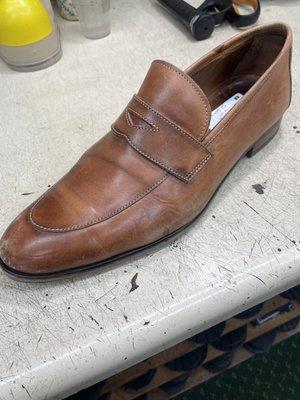 Tan loafer in need of attention.