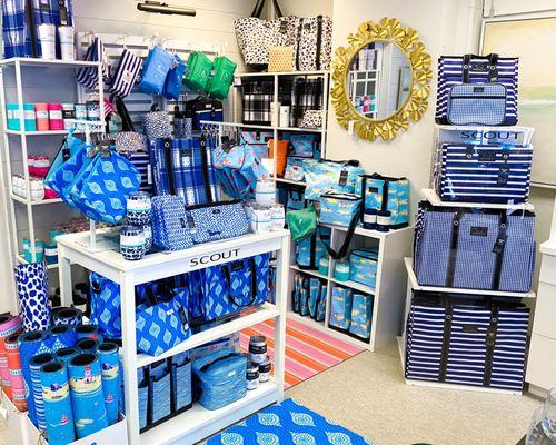 Scout bags display. Rugs, totes, purses, makeup bags, grocery bags, weekender bags, coolers, lunch boxes.