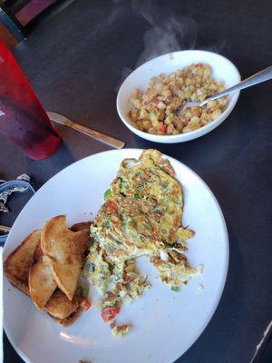 Delhi masala omelet grilled toast and has browns.