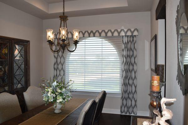 Dining room features Hunter Douglas Alustra Silhouette Shades in the open position.