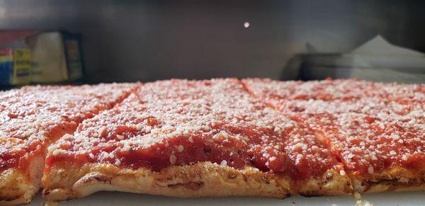 Sicilian Pizza " Our Legendary Favorite"  Family recipe of homemade tomato sauce sprinkled with Pecorino Romano Cheese.