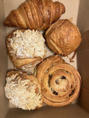 Top clockwise: butter croissant, chocolate croissant, raisin snail, almond croissant, almond chocolate croissant