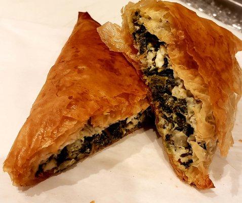 Spanakopita phyllo hand pie stuffed with fresh herbs,feta and spinach