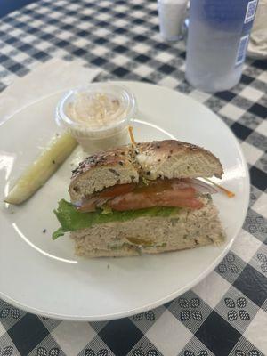 Tuna fish sandwich on an everything bagel with potato salad