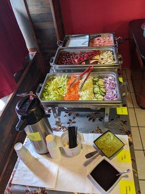 Lunch buffet with masala tea and fresh veggies and fruit