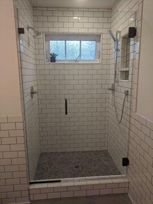 New construction ADU shower door and panel installation. Matte black hardware 3/8 inch glass. Everything lines up perfectly!