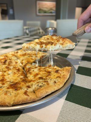 Cheesy White Pie Specialty Pizza with Creamy Garlic Sauce, Cheddar, Feta, and Parmesan cheeses