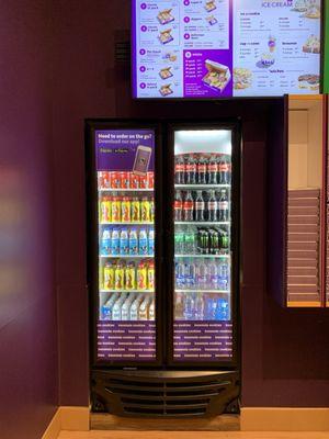 Drink fridge stocked with soda and bottled milk