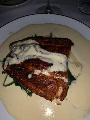 Blackened salmon with lemon caper sauce over sautéed spinach