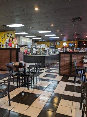 Large seating surrounding open kitchen which I'm all about