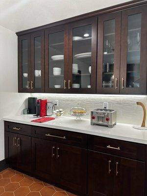 Coffee bar: espresso shaker cabinetry, glass doors upper cabinets, porcelain subway tiles backsplash, brass finish handles.