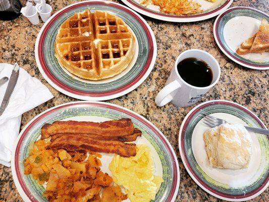 Belgian waffle, biscuit, bacon, eggs, hash brown, white toast and coffee