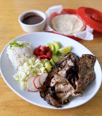 Poc-Chuc: Marinated Pork w/ diced cabbage, avocado, red salsa, radish, beans, rice, handmade tortillas | $16.50