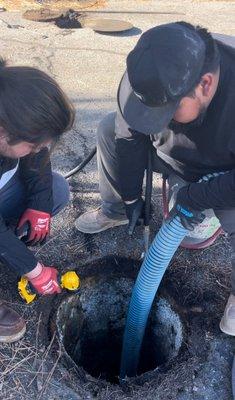 Technicians pumping out a septic tank