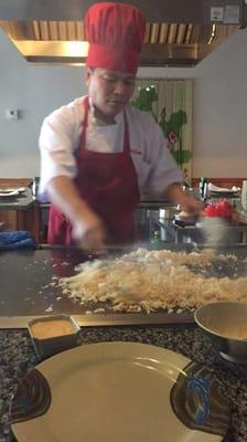 Friendly chef frying up some rice