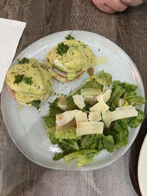 Classic eggs Benedict with side salad freshly shaved Parmesan cheese.