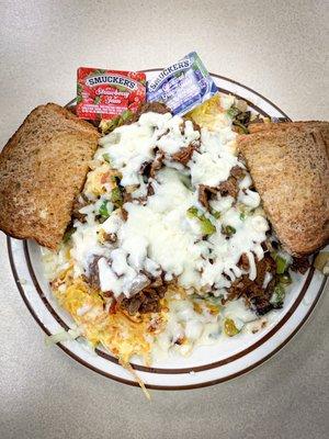 Philly Scramble - hash browns topped with scrambled eggs, philly beef, sautéed green peppers + onions, and covered in melted cheese.