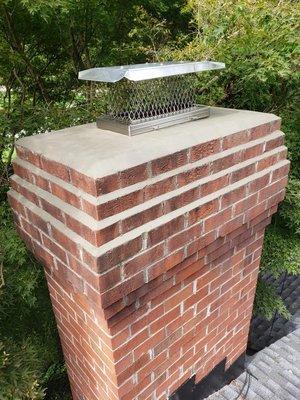 After Pic - Resurfaced chimney crown and corbels as needed and stainless steel chimney cap installed.