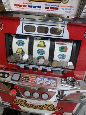 Slot machine that was transported upside down with coins now in all the electrical gears.