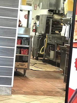 Cardboard on the kitchen floor where they make food.