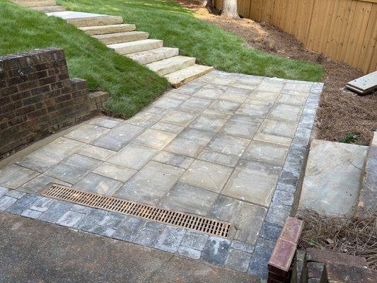 Zeon zoysia sod with flagstone steps and concrete walkway. You can also see the privacy fence we installed a few months ago.