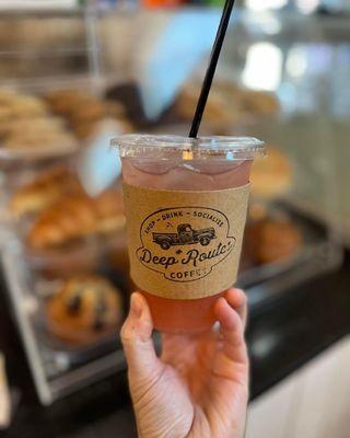 Picture of one of our iced teas, you can get any flavor in your tea or lemonade.  Pastries we offer in the background