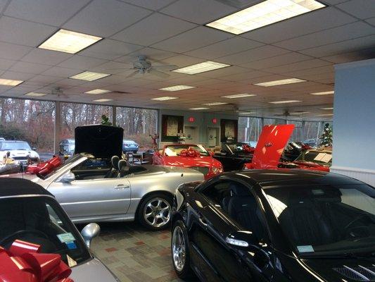 Show room with all makes and models of cars, from practical to exotic.