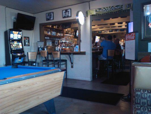 This is from a booth looking past the pool table and into the bar.Up top and left,those are photos of Sean Connery and Charles Bronson.