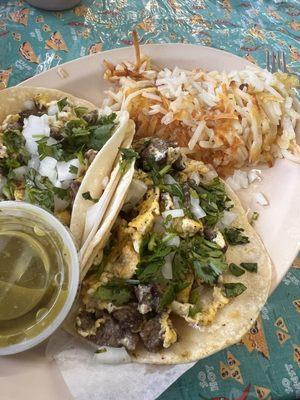 Carne asada breakfast tacos with a side of hashbrowns