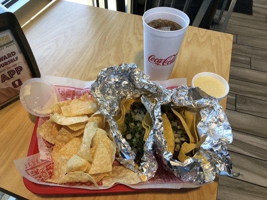 Steak tacos, cheese dip, and a coke.