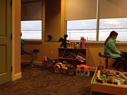 More toys & books, plus the Pacman table on the right & a nook with both PS and Xbox games on the left.