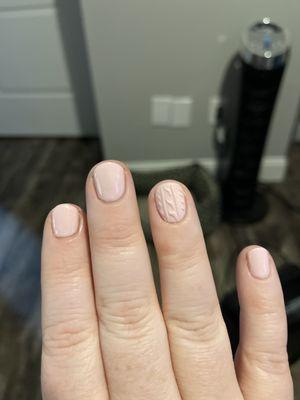 Short round gel manicure with a sweater nail