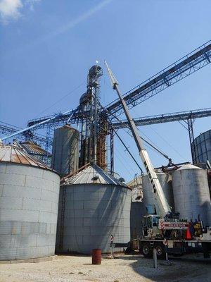 Taking down pieces from a grain bin.