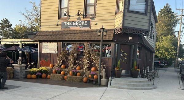 Front door and side display of Fall decor. The outside patio is to the left of pumpkins.