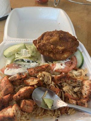 Grilled Chicken with rice and salad, also one piece of fried chicken breast