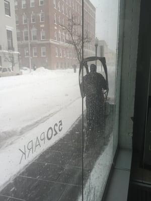 This is Maintenance Man John Mowrey battling the blizzard keeping the sidewalks clean and safe for the residents, He treats us like family.