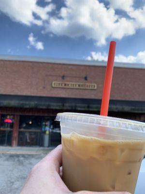 Iced Caramel Royale in front of the cafe