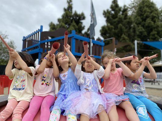 Exploring imagination through handmade telescopes in the Pirate Ship playground.