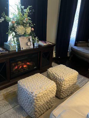 Ottomans and a fireplace in the waiting area